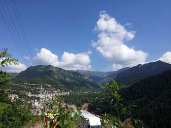 Scenic view of mountains against blue sky