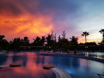 Scenic view of swimming pool against sky during sunset