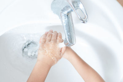 High angle view of woman hand in water