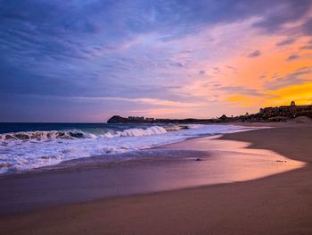 Scenic view of beach against sky during sunset