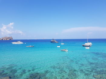 Sailboats in sea against sky