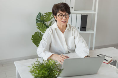 Young woman using laptop at office