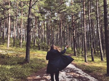 Rear view of woman in forest