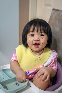 Little girl enjoy eating dragon fruit and mouth full of food scraps. 