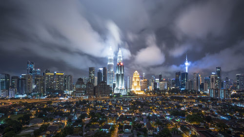 View of illuminated cityscape against sky at night