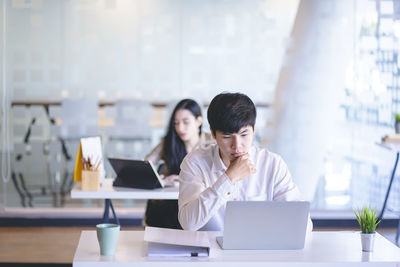 People working on table in office