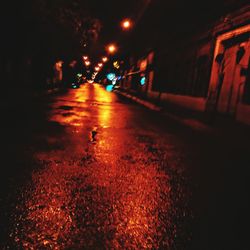 Illuminated road in city at night