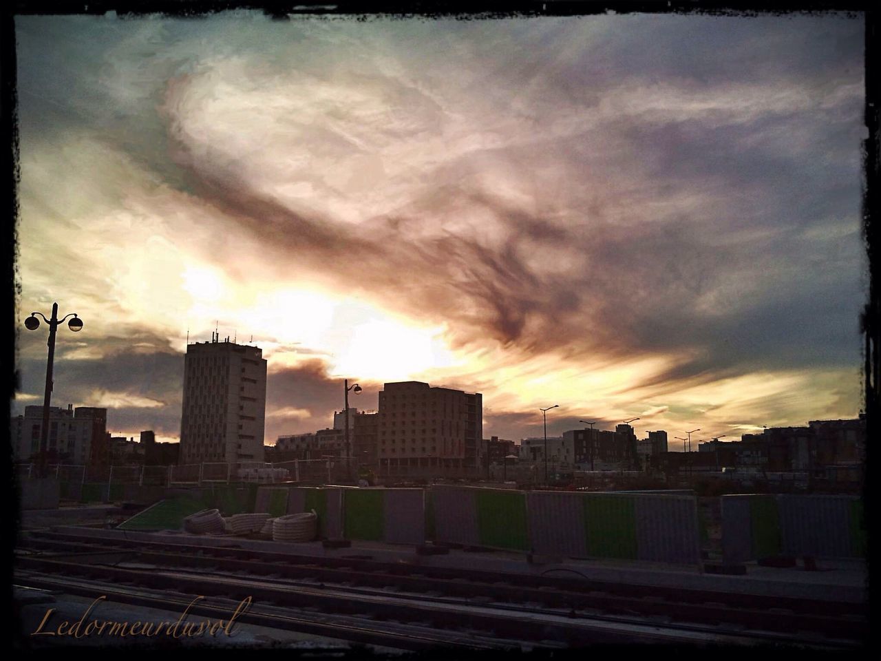 building exterior, sky, architecture, built structure, cloud - sky, transfer print, cloudy, auto post production filter, weather, sunset, overcast, city, dusk, transportation, cloud, silhouette, outdoors, residential building, storm cloud, building