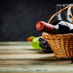 Close-up of wine bottle in basket on table