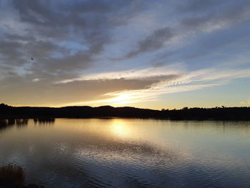 Scenic view of lake against sky during sunset