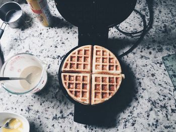 High angle view of waffles on iron