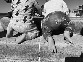 Rear view of men sitting on street