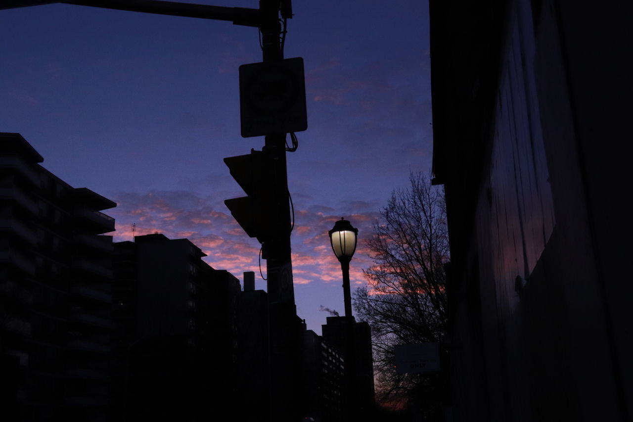 LOW ANGLE VIEW OF STREET LIGHT AGAINST BUILDINGS