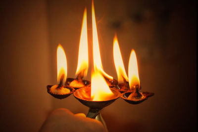 Close-up of lit candle in the dark