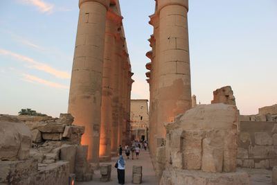 Tourists at historical building against sky