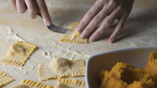 Cropped image of woman preparing food on table