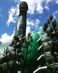 Low angle view of trees and buildings against sky