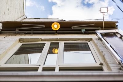 Low angle view of yellow building against sky