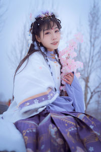 A girl in hanfu in the snow