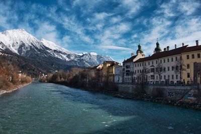 River amidst buildings against sky