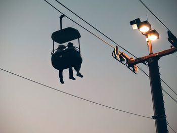 Overhead cable car against clear sky