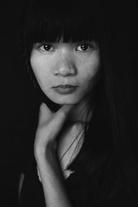 Portrait of smiling woman on black background 