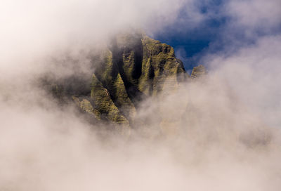 Fluted rocks of the na pali mountains through the clouds from pihea trail near pu'u o kila on kauai