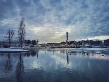 Scenic view of lake against sky during winter