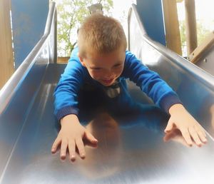 Rear view of boy looking at camera