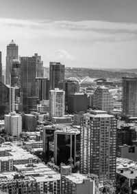 Tall buildings in downtown seattle, washington with mount rainier in the distance