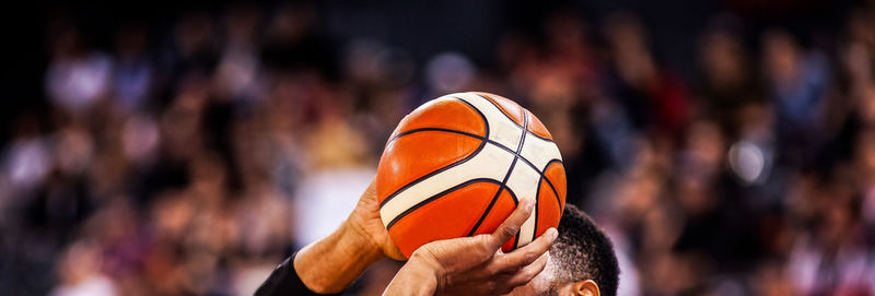 Close-up of hand holding ball against blurred background