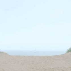 Scenic view of beach against clear sky