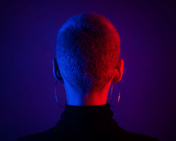 Close-up of woman against blue background