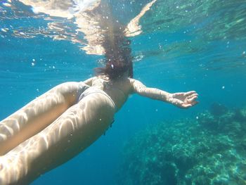 Young woman swimming undersea