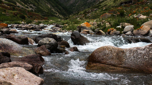 Stream flowing through rocks in river