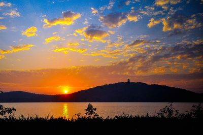 Scenic view of lake against sky during sunset