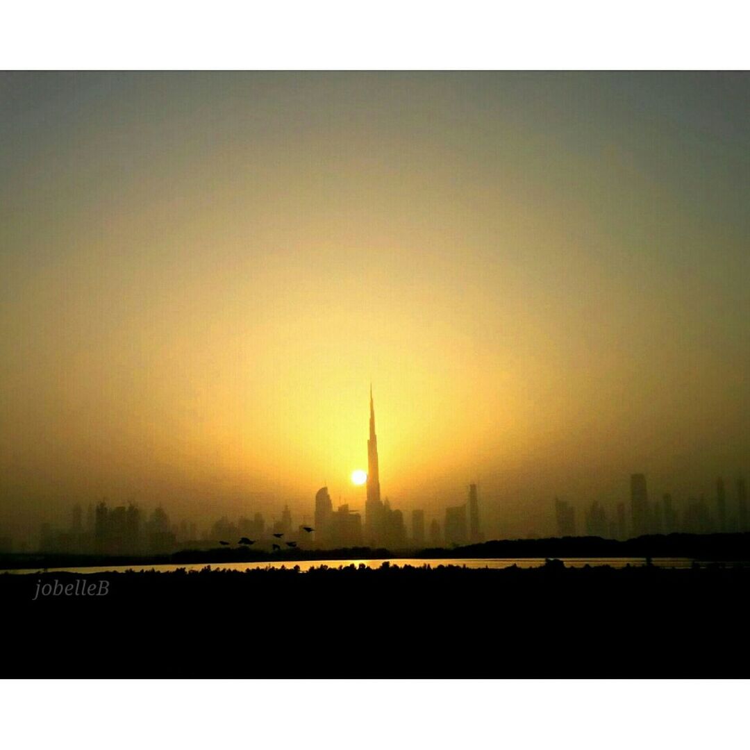 transfer print, architecture, built structure, sunset, building exterior, city, auto post production filter, tower, copy space, cityscape, clear sky, sun, travel destinations, capital cities, skyscraper, tall - high, silhouette, international landmark, famous place, orange color