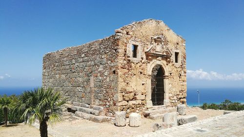 Low angle view of historical building against blue sky