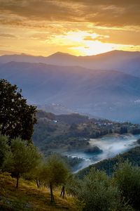 Scenic view of mountains against sky during sunset