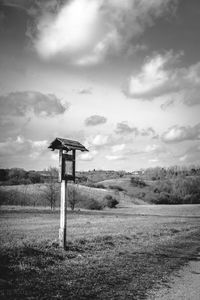 Lifeguard hut on field against sky