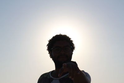Portrait of mid adult man against sky during sunset