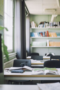 Books and supplies on desk in empty classroom