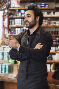 Man gesturing while standing in shoe store