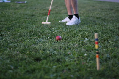 Low section of man playing soccer on field