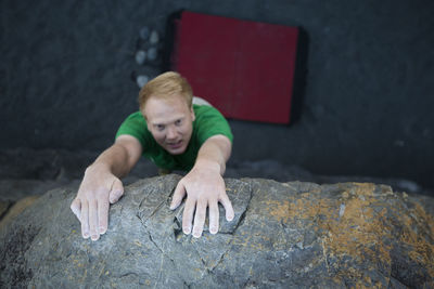 High angle view of man climbing rock