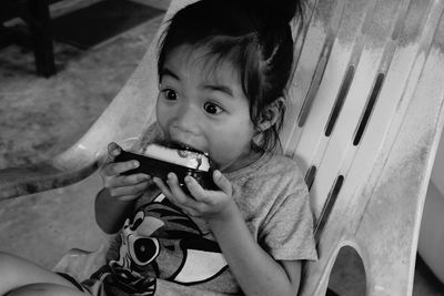 Portrait of cute boy sitting outdoors