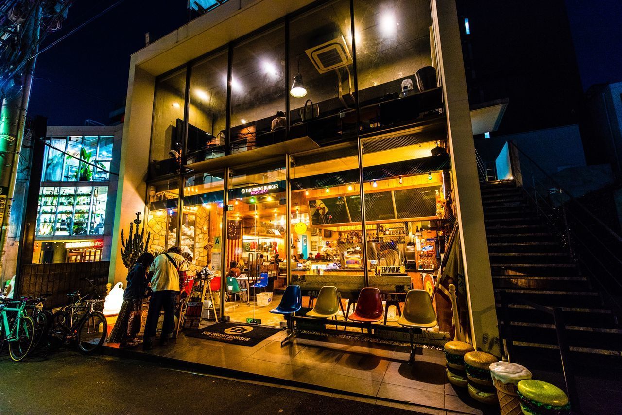 PEOPLE ON ILLUMINATED STREET AT NIGHT