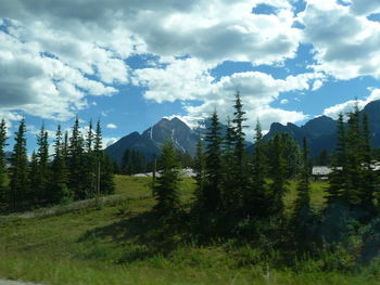Scenic view of mountains against cloudy sky