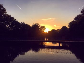 Scenic view of lake against sky at sunset