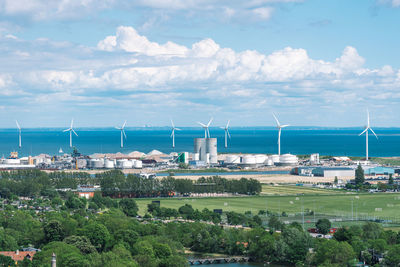 Offshore wind turbines power in a row in the baltic sea, industrial district of copenhagen, denmark